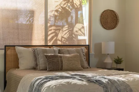 a bedroom with a bed and a painting on the wall