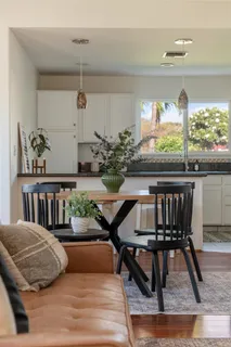 a view of a dining room with furniture window and wooden floor