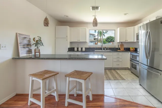 a kitchen with granite countertop cabinets and stainless steel appliances