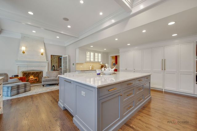 a dining room with furniture a chandelier and wooden floor