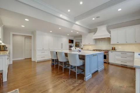 a kitchen with a dining table chairs sink and cabinets