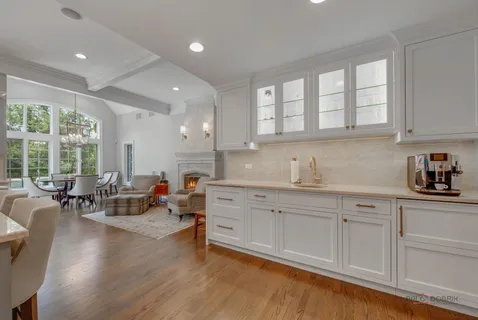 a living room with fireplace furniture and a large window