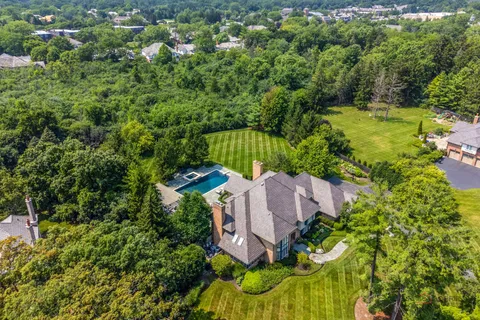 an aerial view of a house with garden space and street view