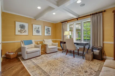 a view of a livingroom with a flesh screen tv and couches