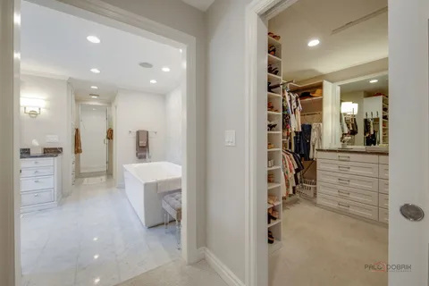 a bathroom with double vanity sinks a vanity and a large mirror