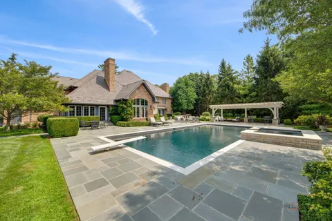 a view of a house with swimming pool and a yard