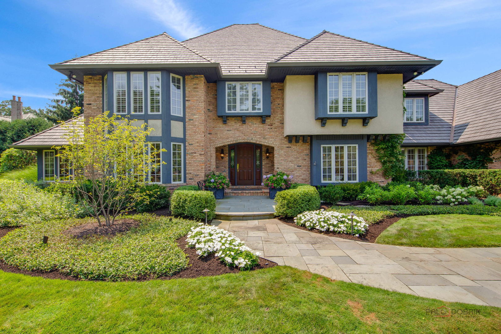 1090 Evergreen Drive Lake Forest, IL 60045 - Photo 5 of 66 a front view of a house with a yard and potted plants
