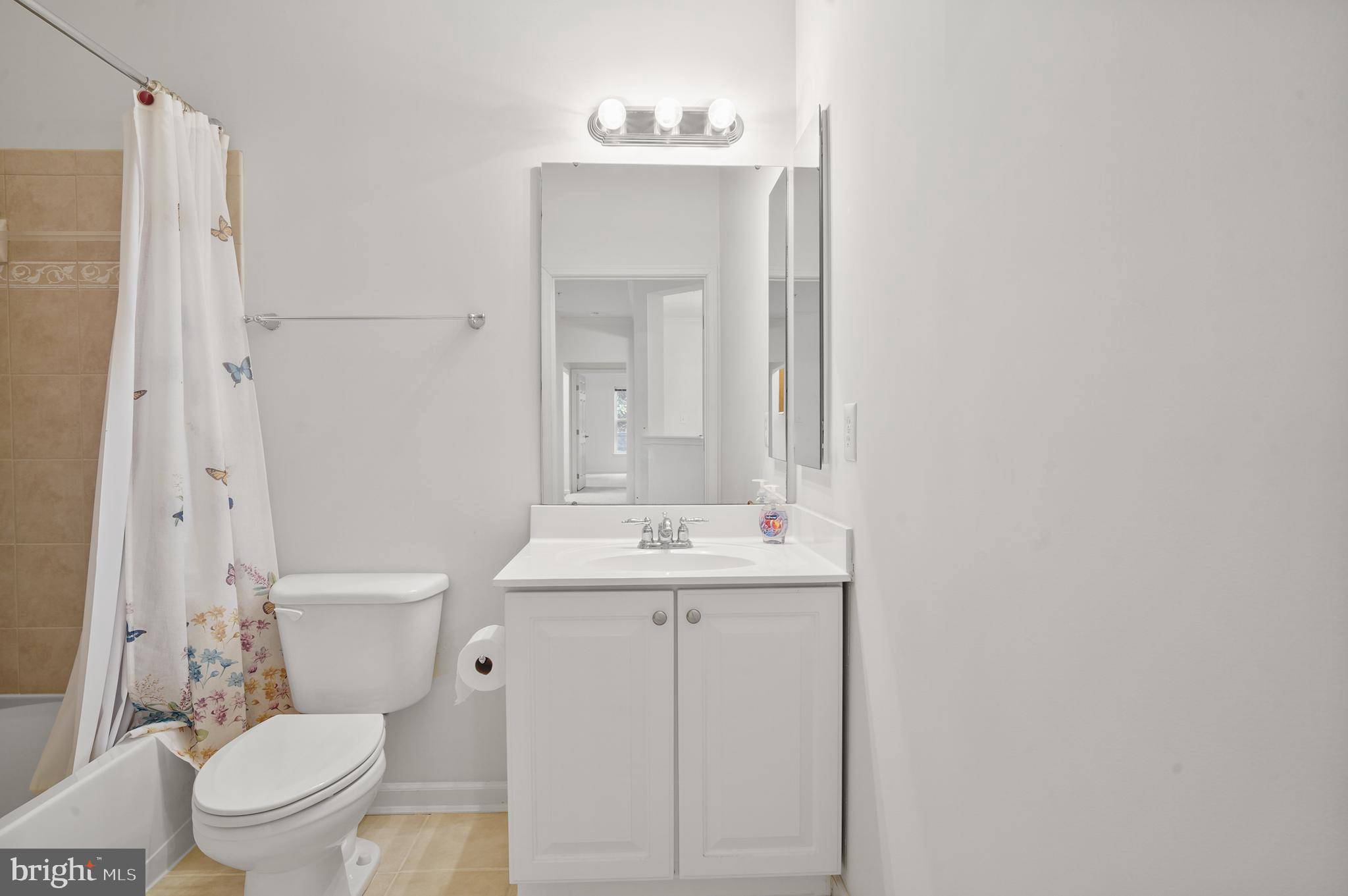 1014 Samantha Lane, Unit 102 Odenton, MD 21113 - Photo 12 of 32 a bathroom with a toilet a sink and mirror