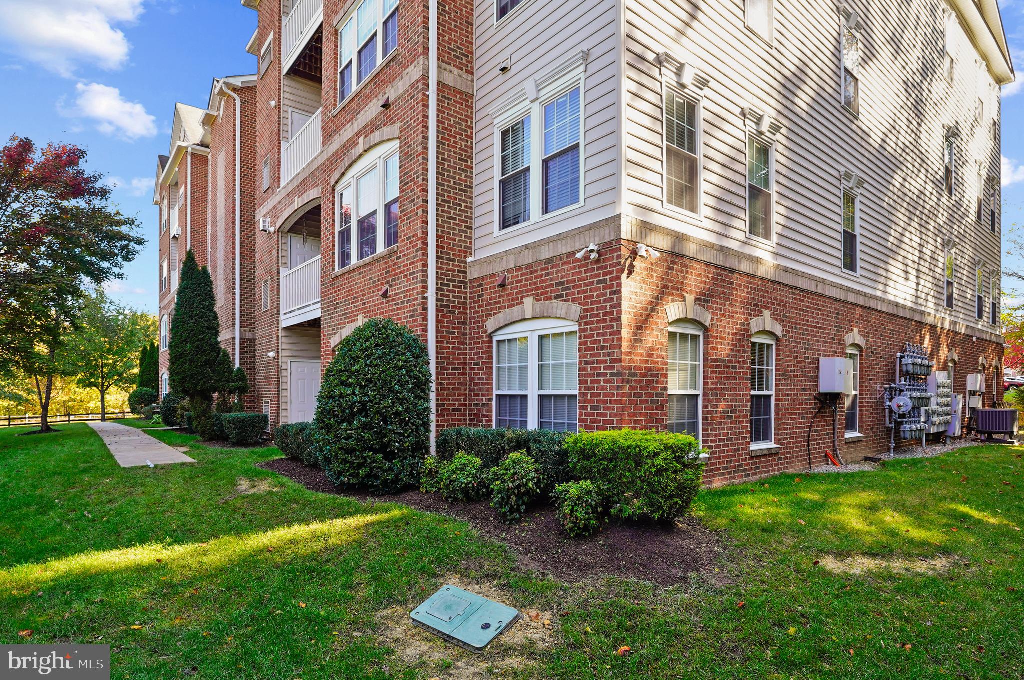 1014 Samantha Lane, Unit 102 Odenton, MD 21113 - Photo 19 of 32 a view of a building with a yard