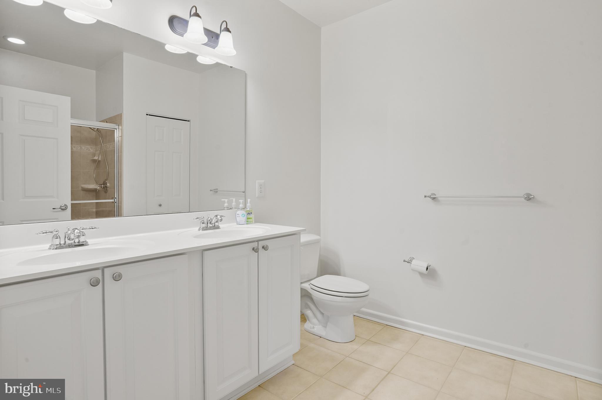 1014 Samantha Lane, Unit 102 Odenton, MD 21113 - Photo 23 of 32 a bathroom with a sink a toilet and a mirror