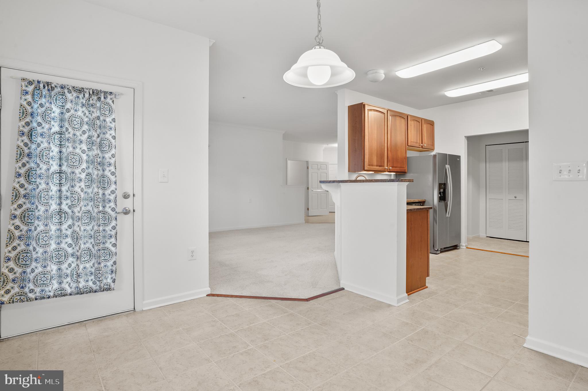 1014 Samantha Lane, Unit 102 Odenton, MD 21113 - Photo 30 of 32 a view of kitchen with refrigerator cabinets and window