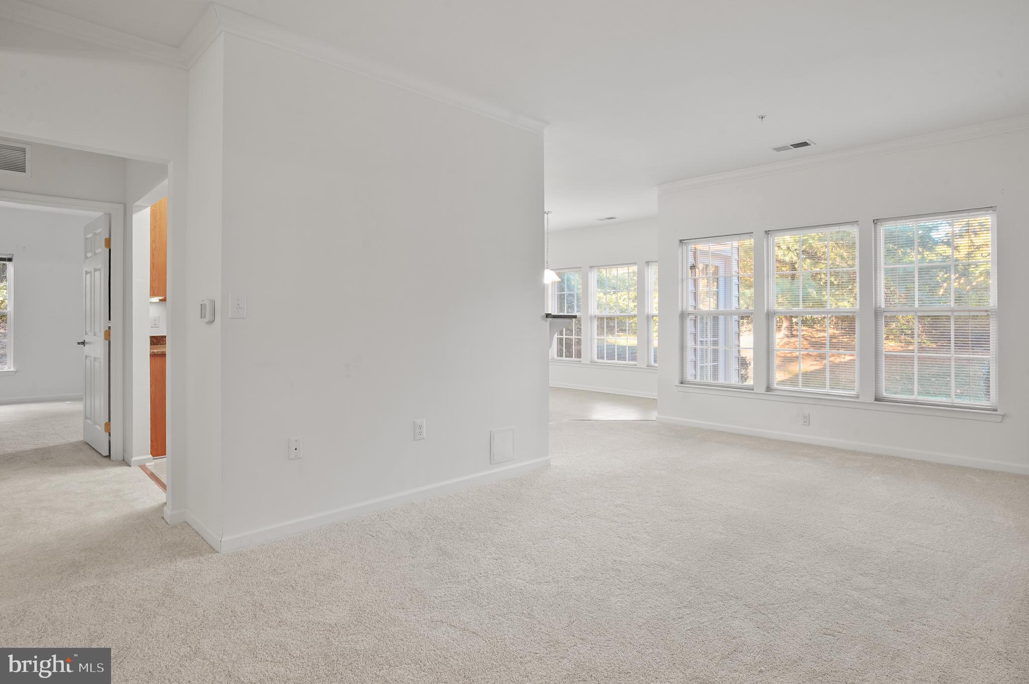 1014 Samantha Lane, Unit 102 Odenton, MD 21113 - Photo 9 of 32 wooden floor in an empty room with a window