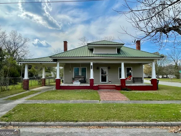 a view of a house with sitting area and a garden