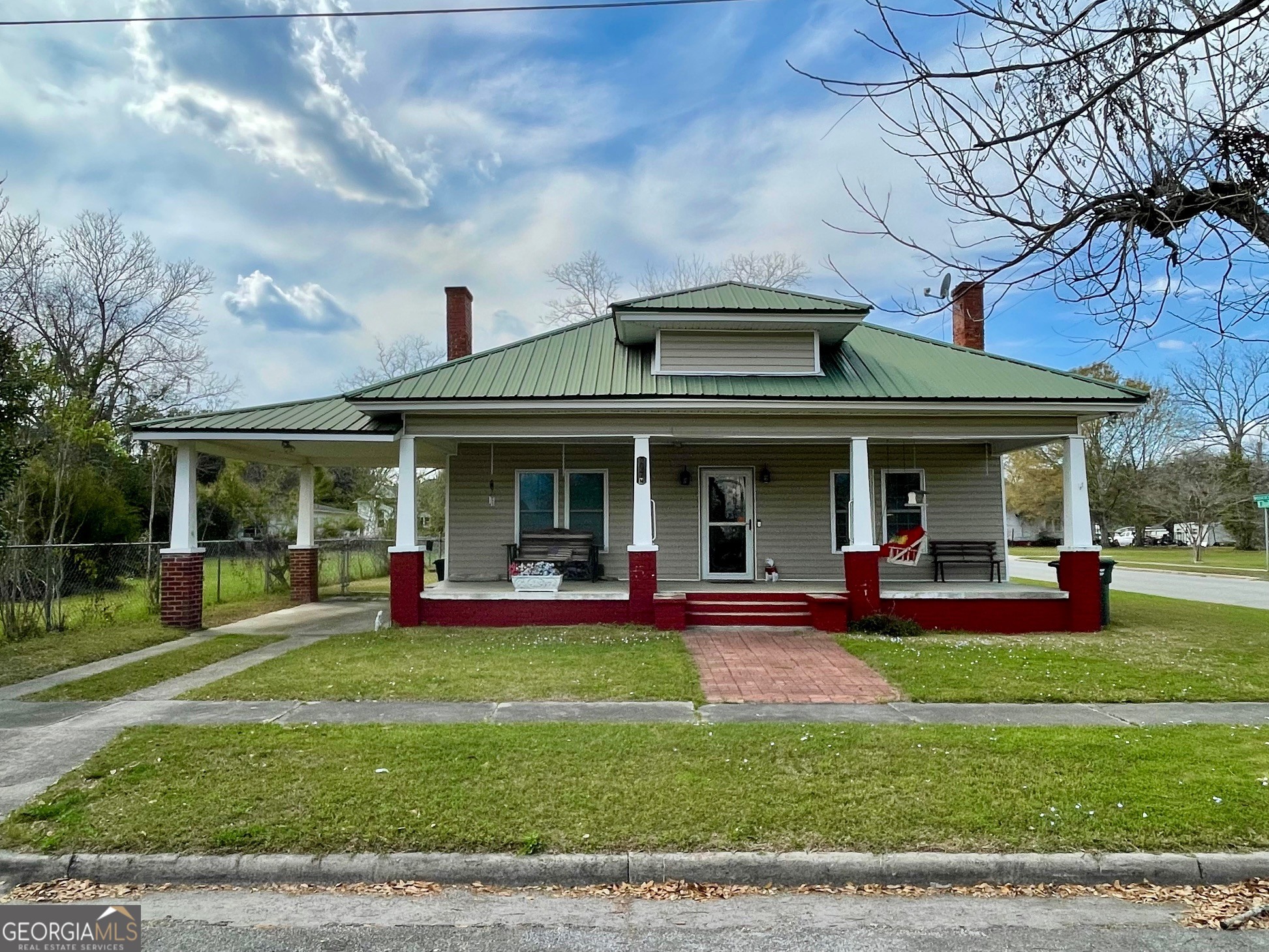 a view of a house with sitting area and a garden
