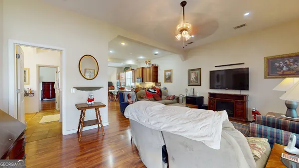 a living room with furniture a flat screen tv and a large window