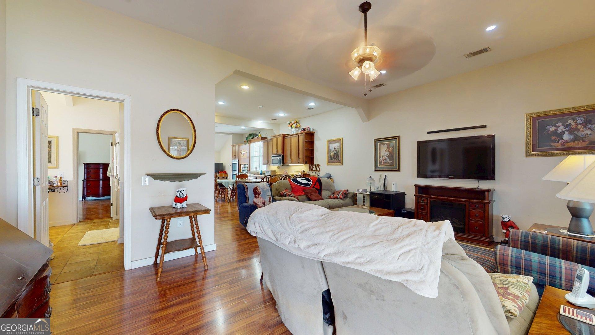 297 North Rountree Street Metter, GA 30439 - Photo 12 of 34 a living room with furniture a flat screen tv and a large window