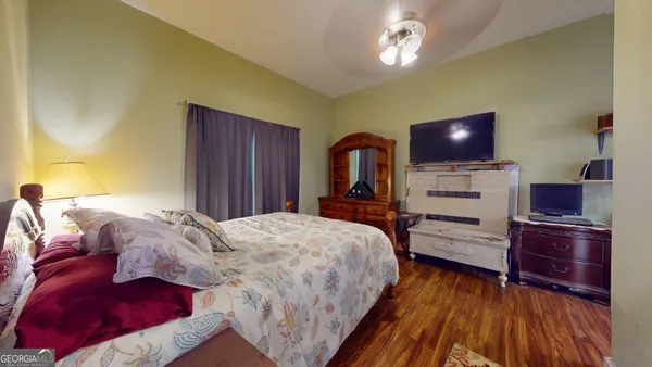 a bedroom with a bed and a flat screen tv