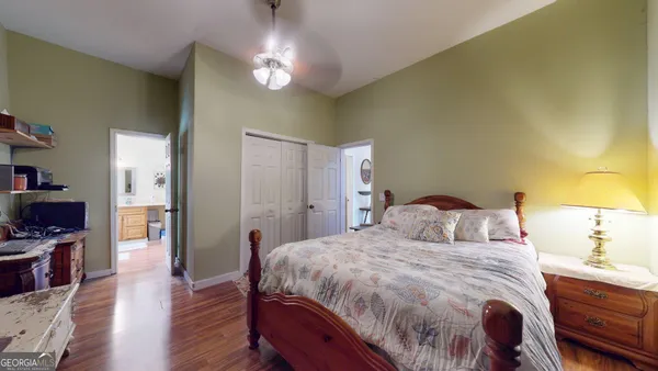a bedroom with a bed and wooden floor