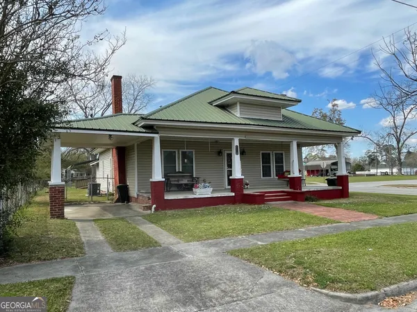 a view of a house with sitting area and garden