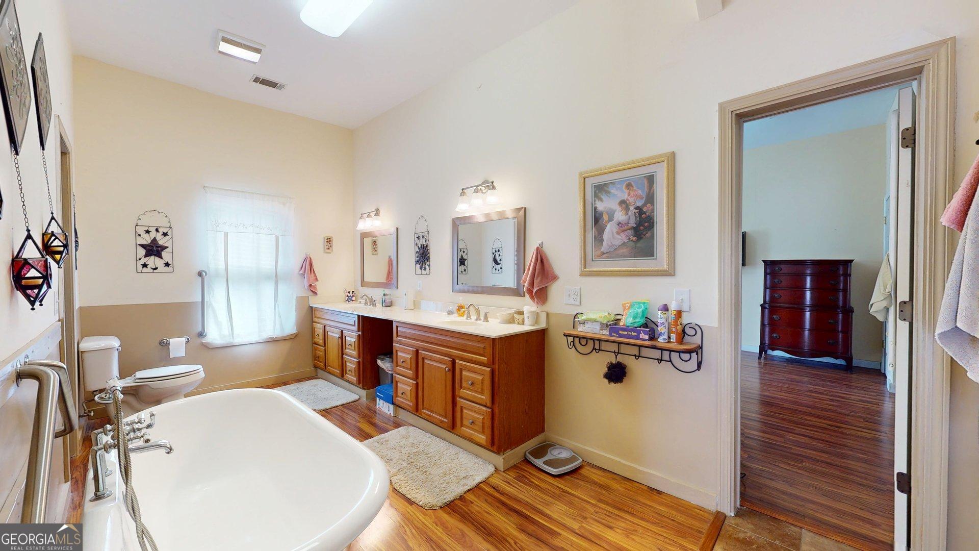 297 North Rountree Street Metter, GA 30439 - Photo 21 of 34 a living room with furniture and a wooden floor