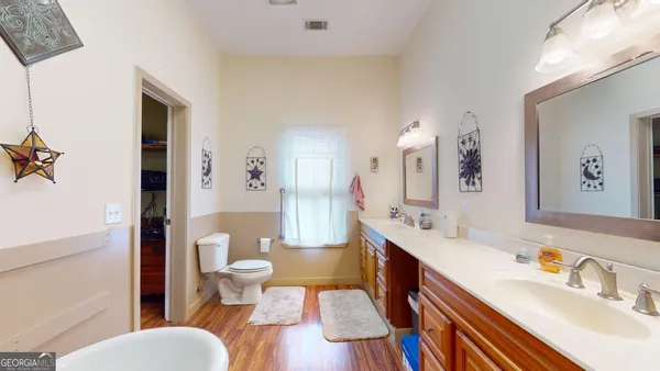 a bathroom with a sink double vanity and a toilet
