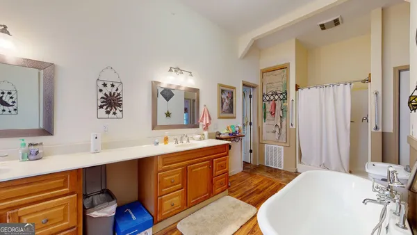 a en suite bathroom with a double vanity sink a mirror and a shower