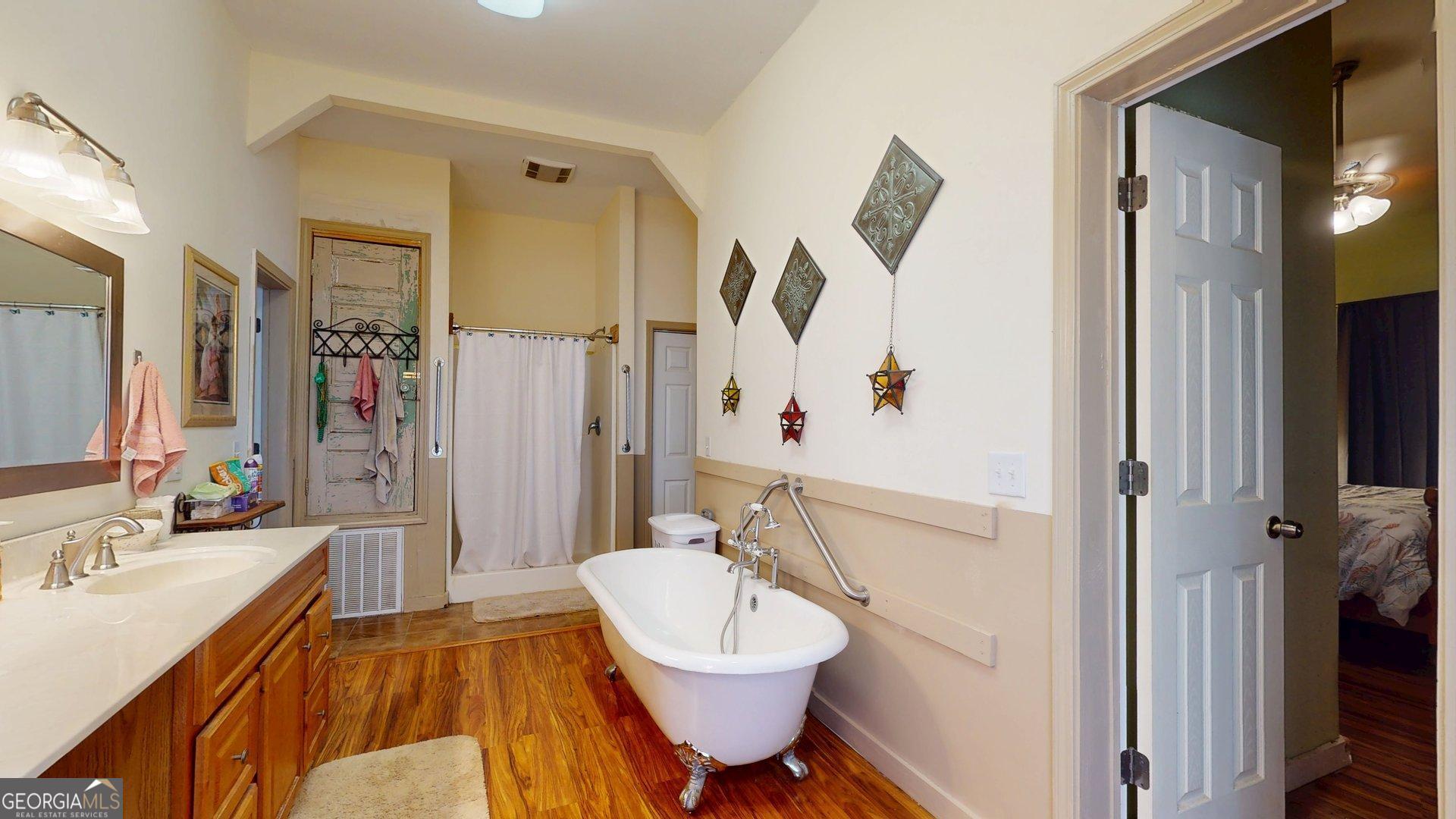 297 North Rountree Street Metter, GA 30439 - Photo 25 of 34 a bathroom with a sink a toilet and shower