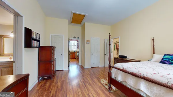 a bedroom with a bed and a flat screen tv