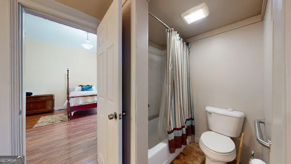 a bathroom with a toilet and a shower curtain