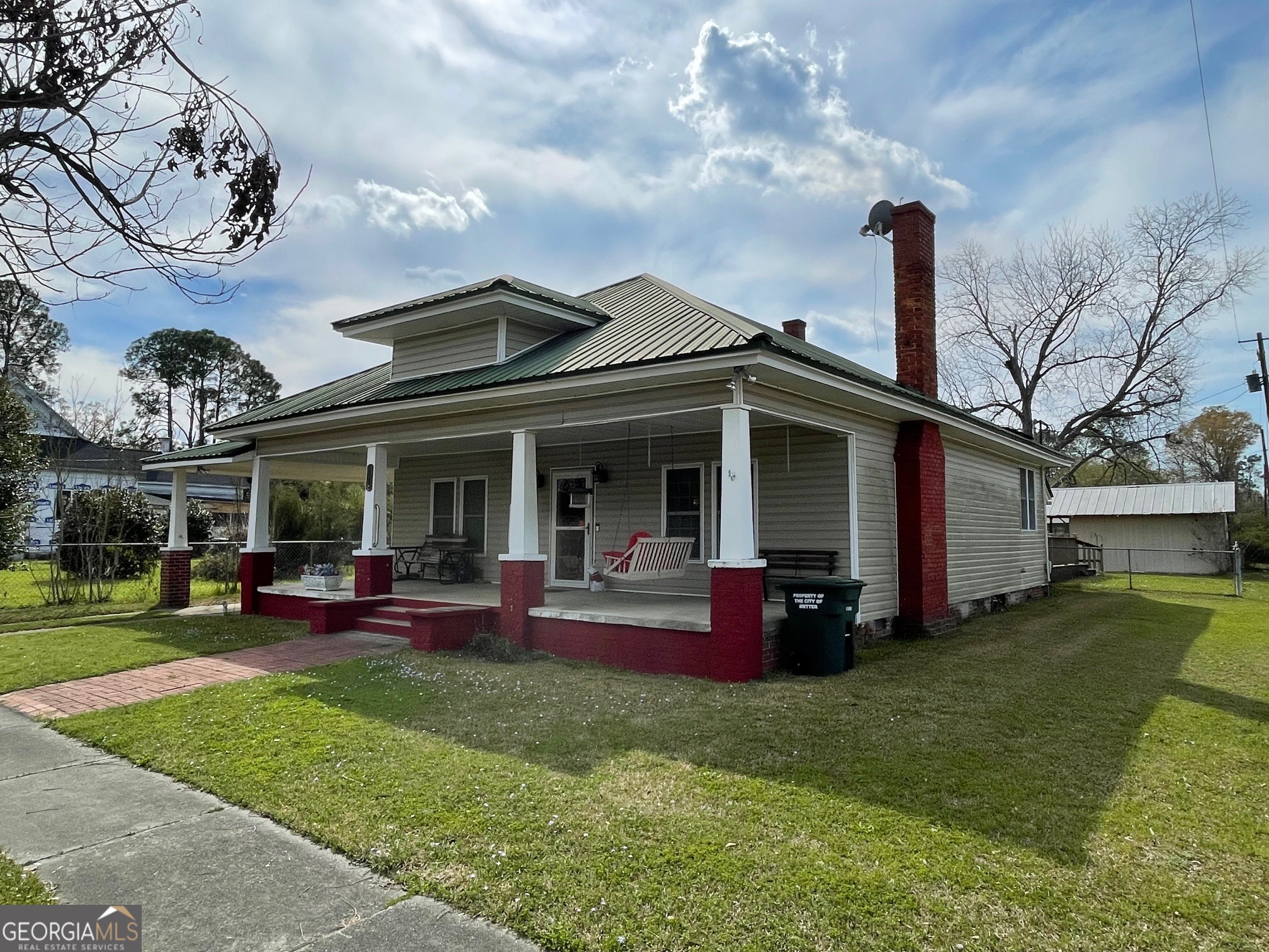 297 North Rountree Street Metter, GA 30439 - Photo 3 of 34 a view of a house with a barbeque grill and a table and chairs