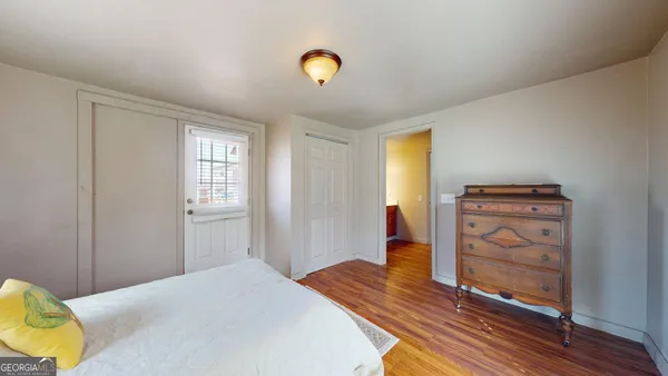 a bedroom with a bed and a dresser