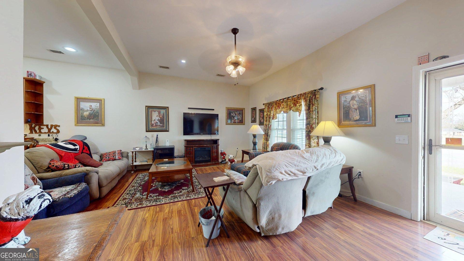 297 North Rountree Street Metter, GA 30439 - Photo 33 of 34 a living room with furniture and a flat screen tv