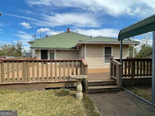 a front view of a house with a bench