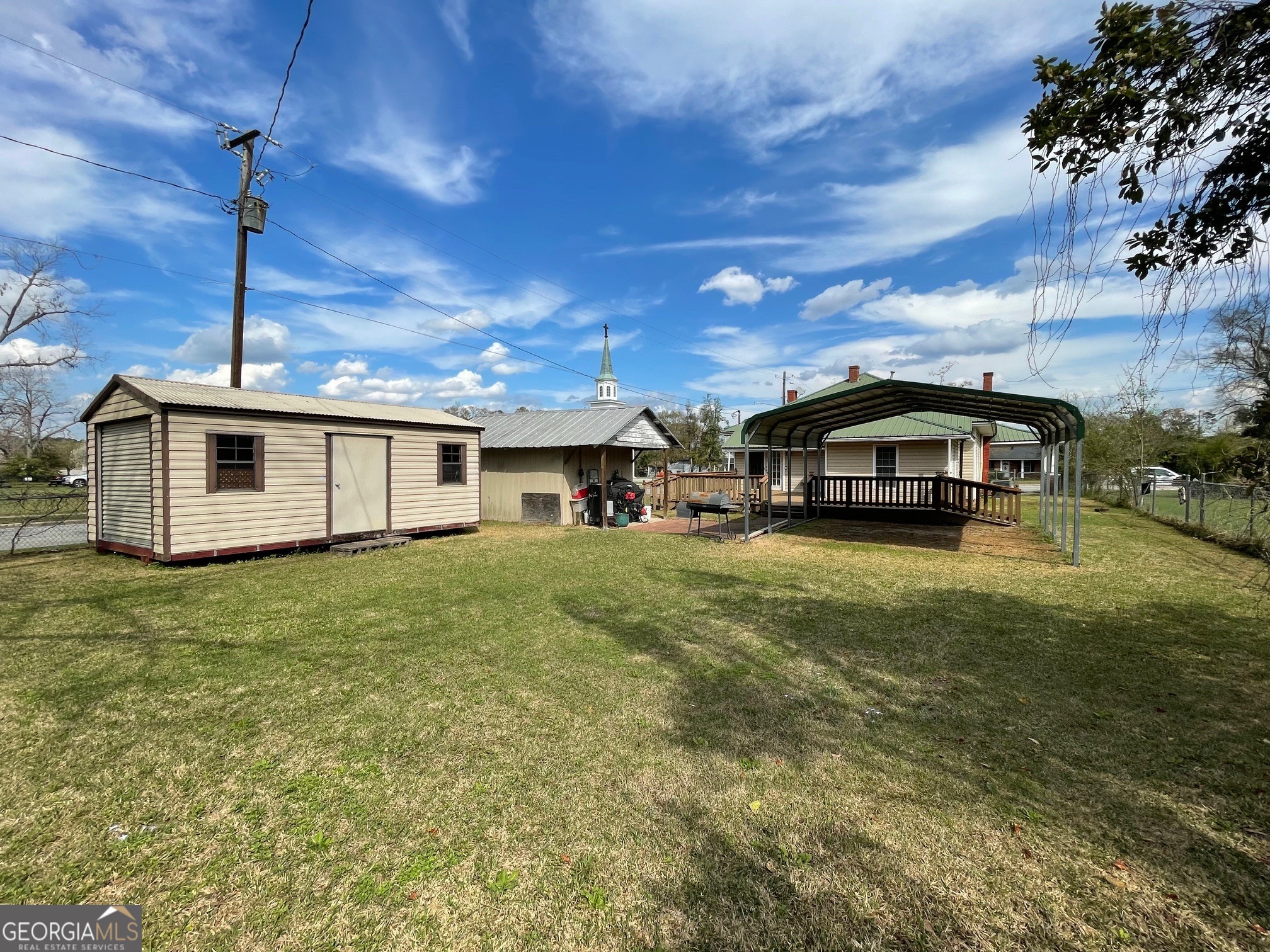 297 North Rountree Street Metter, GA 30439 - Photo 6 of 34 a car parked in front of a house
