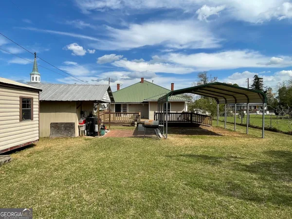 a view of a big house with swimming pool and furniture