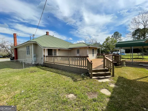 a view of a house with a yard porch and furniture