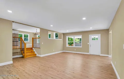 a view of a room that has wooden floor and a window