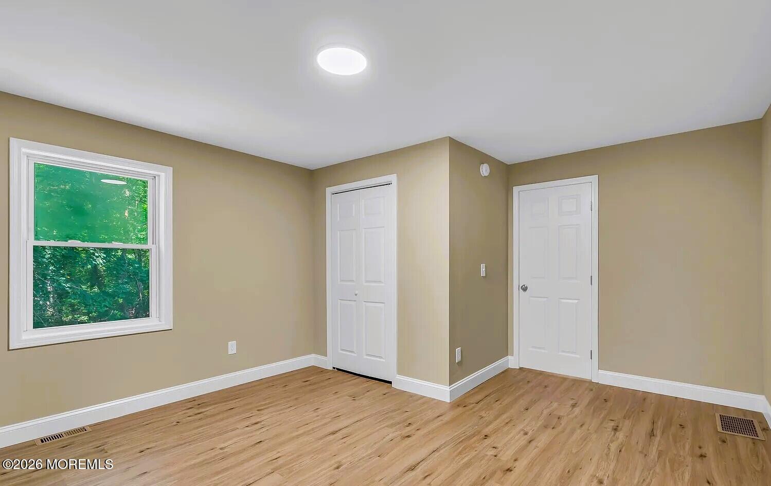 510 Pinehurst Road Cream Ridge, NJ 08514 - Photo 21 of 57 a view of an empty room with wooden floor and window