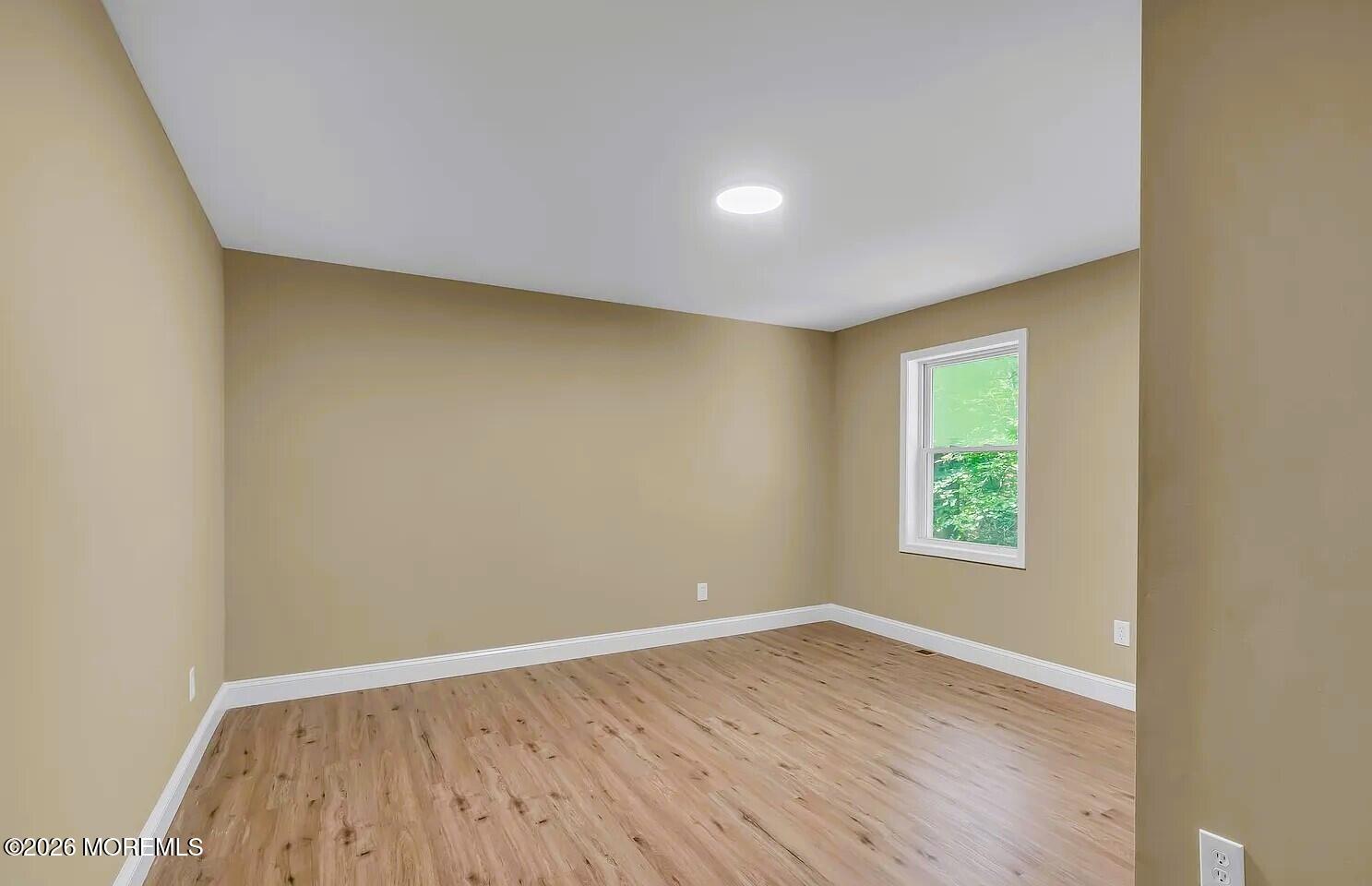 510 Pinehurst Road Cream Ridge, NJ 08514 - Photo 25 of 57 an empty room with wooden floor and windows