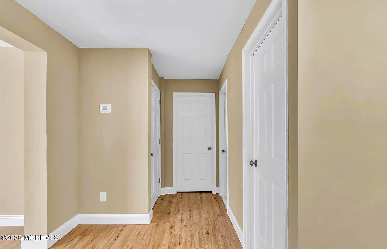 510 Pinehurst Road Cream Ridge, NJ 08514 - Photo 40 of 57 a view of a hallway with wooden floor and closet area
