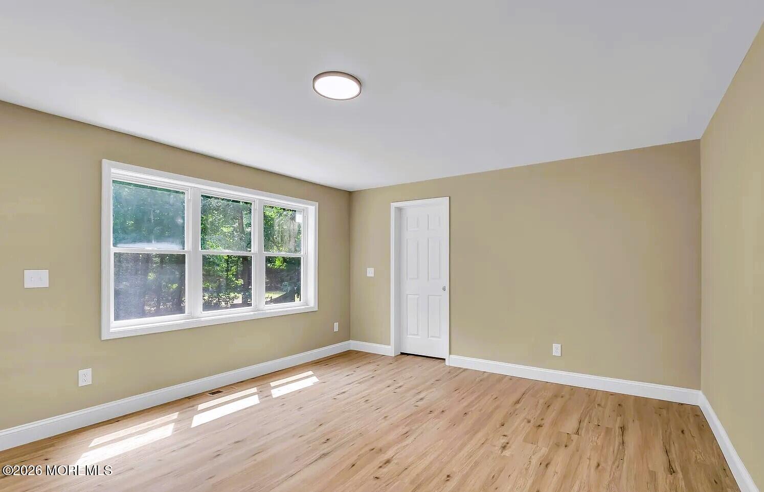 510 Pinehurst Road Cream Ridge, NJ 08514 - Photo 43 of 57 a view of an empty room with wooden floor and a window