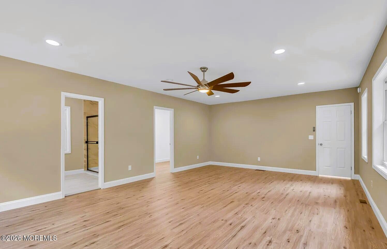 510 Pinehurst Road Cream Ridge, NJ 08514 - Photo 50 of 57 a view of an empty room with wooden floor and a ceiling fan
