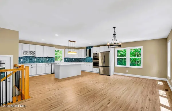 a kitchen with stainless steel appliances granite countertop a sink and cabinets