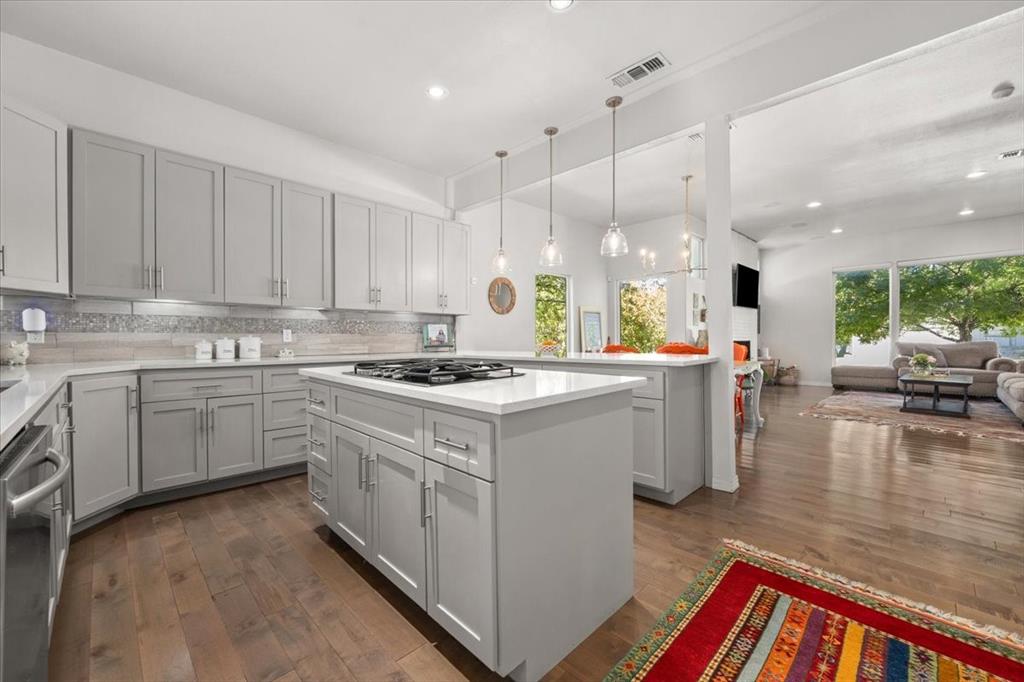 6121 Sharon Road Fort Worth, TX 76116 - Photo 18 of 37 a kitchen that has a lot of cabinets in it and wooden floors