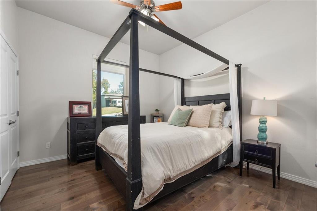 6121 Sharon Road Fort Worth, TX 76116 - Photo 28 of 37 a bedroom with a bed and wooden floor