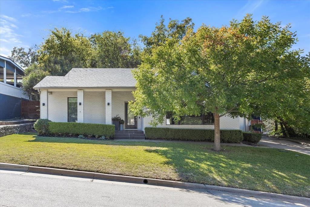 6121 Sharon Road Fort Worth, TX 76116 - Photo 5 of 37 a front view of a house with a yard