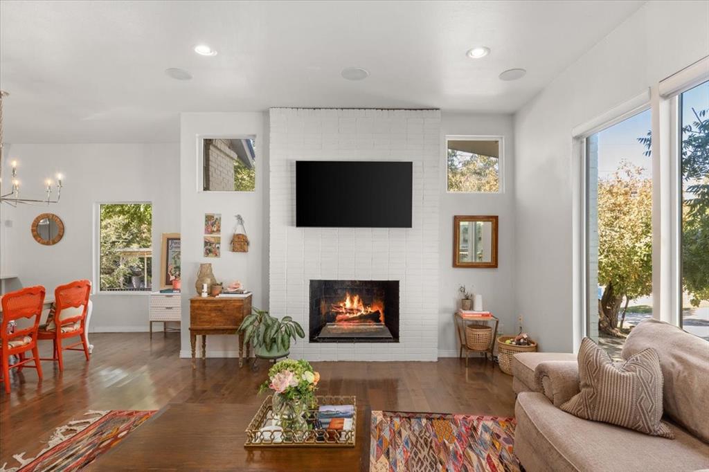 6121 Sharon Road Fort Worth, TX 76116 - Photo 10 of 37 a living room with furniture a flat screen tv and a fireplace