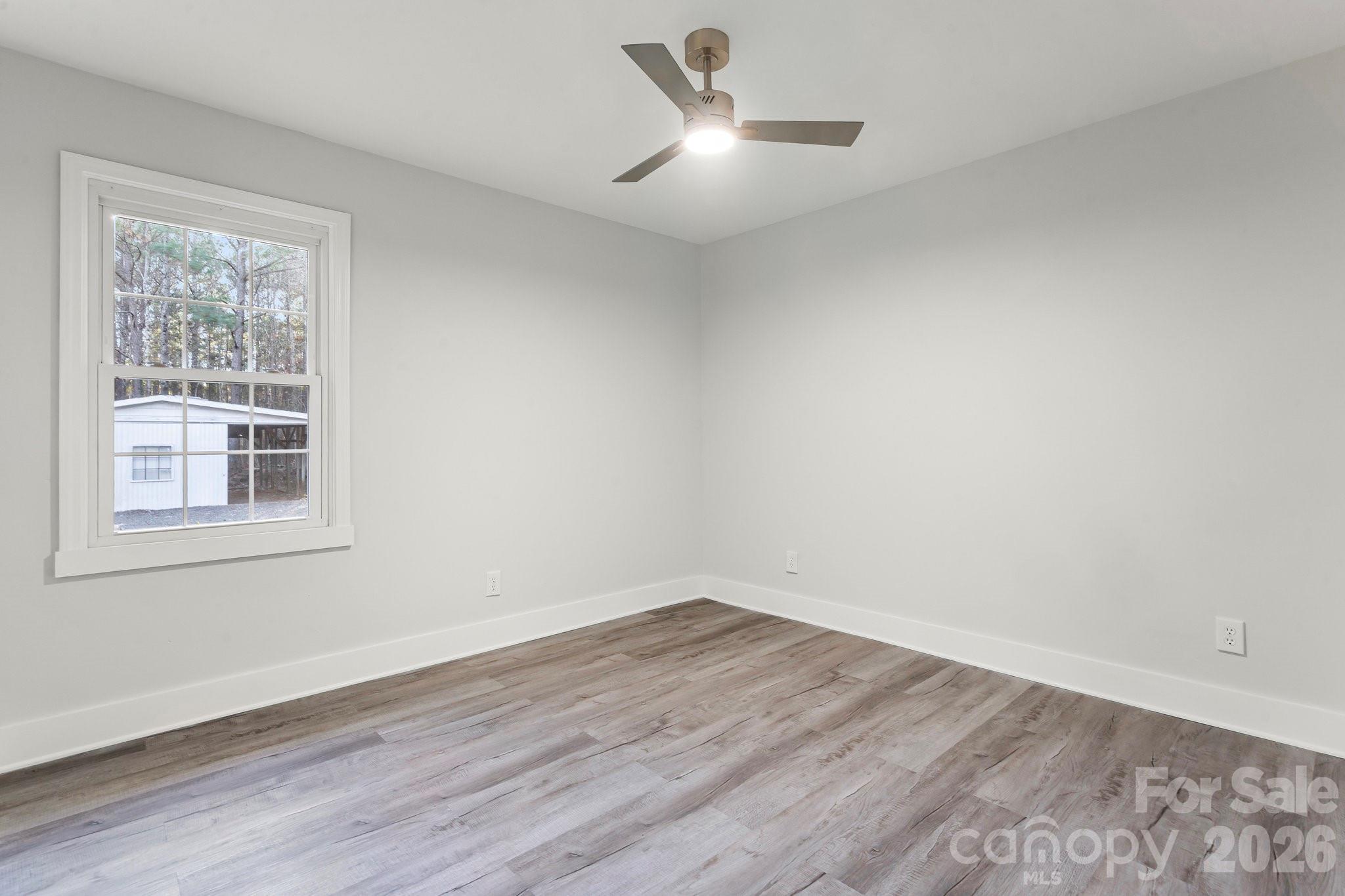 28 Robert Tyson Road Wadesboro, NC 28170 - Photo 12 of 23 a view of empty room with wooden floor and fan