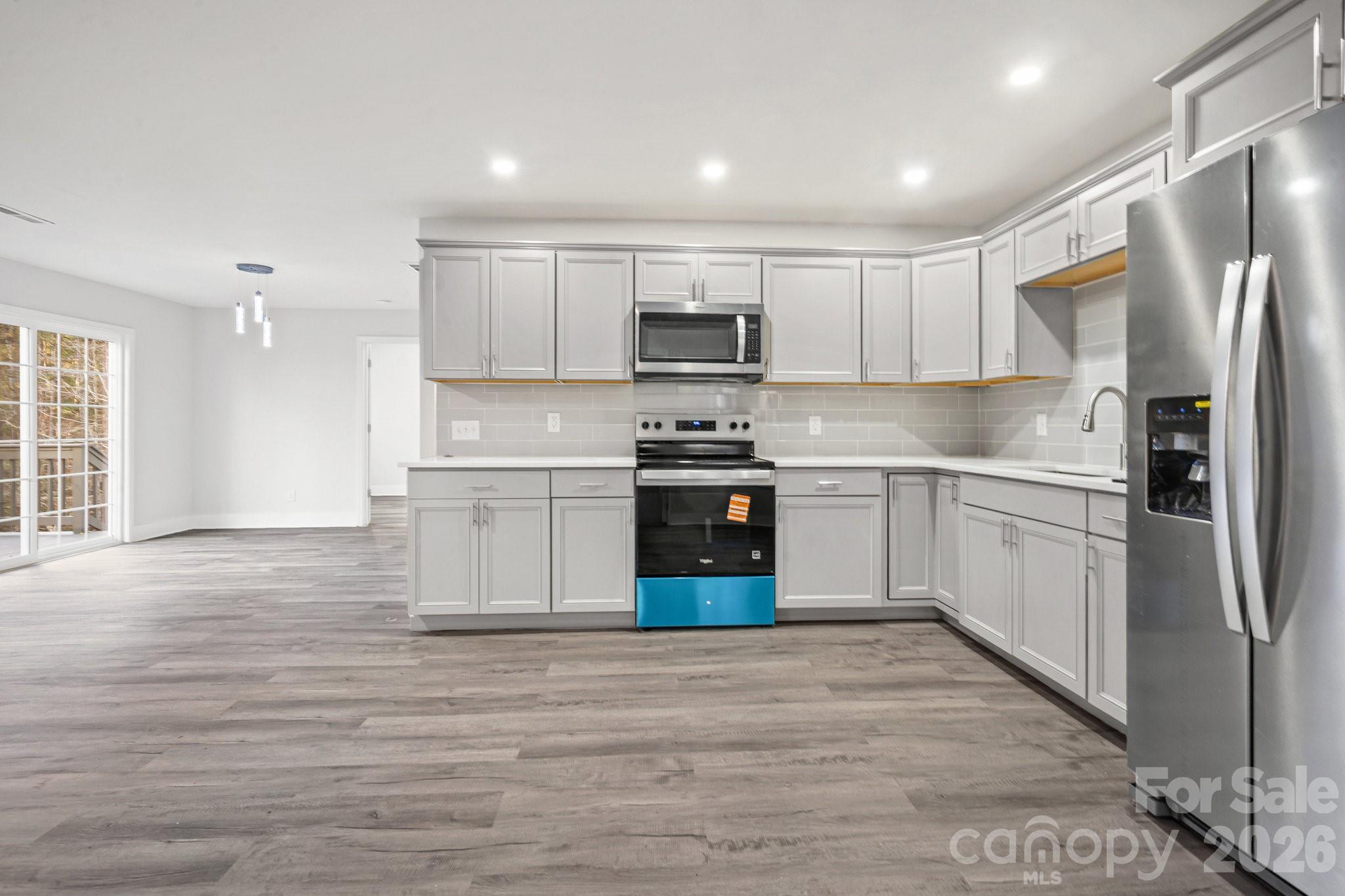 28 Robert Tyson Road Wadesboro, NC 28170 - Photo 4 of 23 a kitchen with stainless steel appliances granite countertop a refrigerator a stove top oven a sink and dishwasher with wooden floor