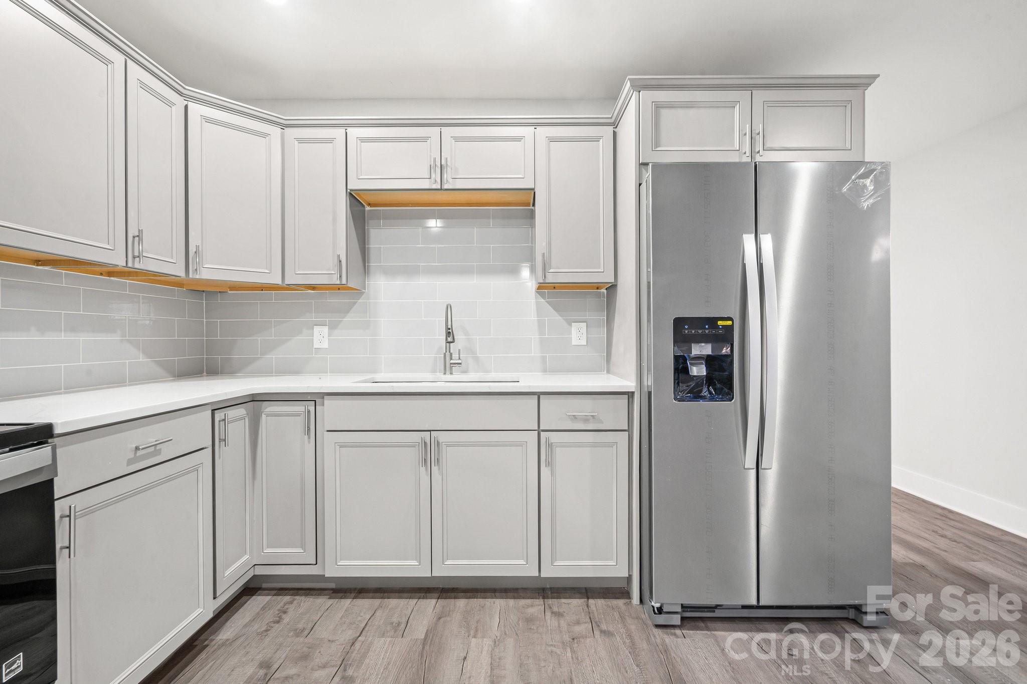 28 Robert Tyson Road Wadesboro, NC 28170 - Photo 5 of 23 a kitchen with white cabinets and refrigerator